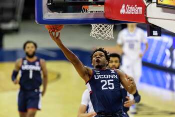 Connecticut forward Josh Carlton (25) drives to the basket for a layup against Creighton in the first half during an NCAA college basketball game Saturday, Jan. 23, 2021, in Omaha, Neb. (AP Photo/John Peterson)