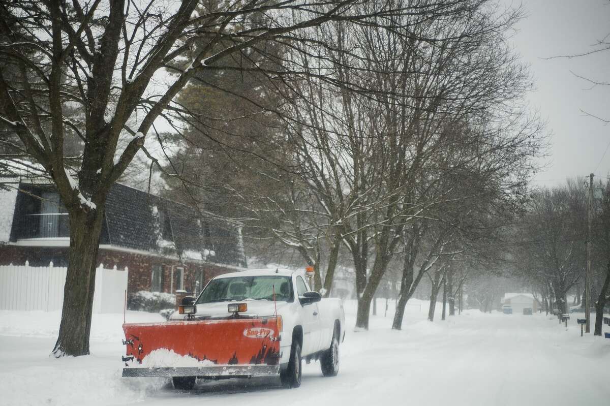 File photo: Midland residents use snowblowers and shovels to clear sidewalks and driveways during a day of constant precipitation Tuesday, Jan. 26, 2021 in Midland. (Katy Kildee/kkildee@mdn.net)