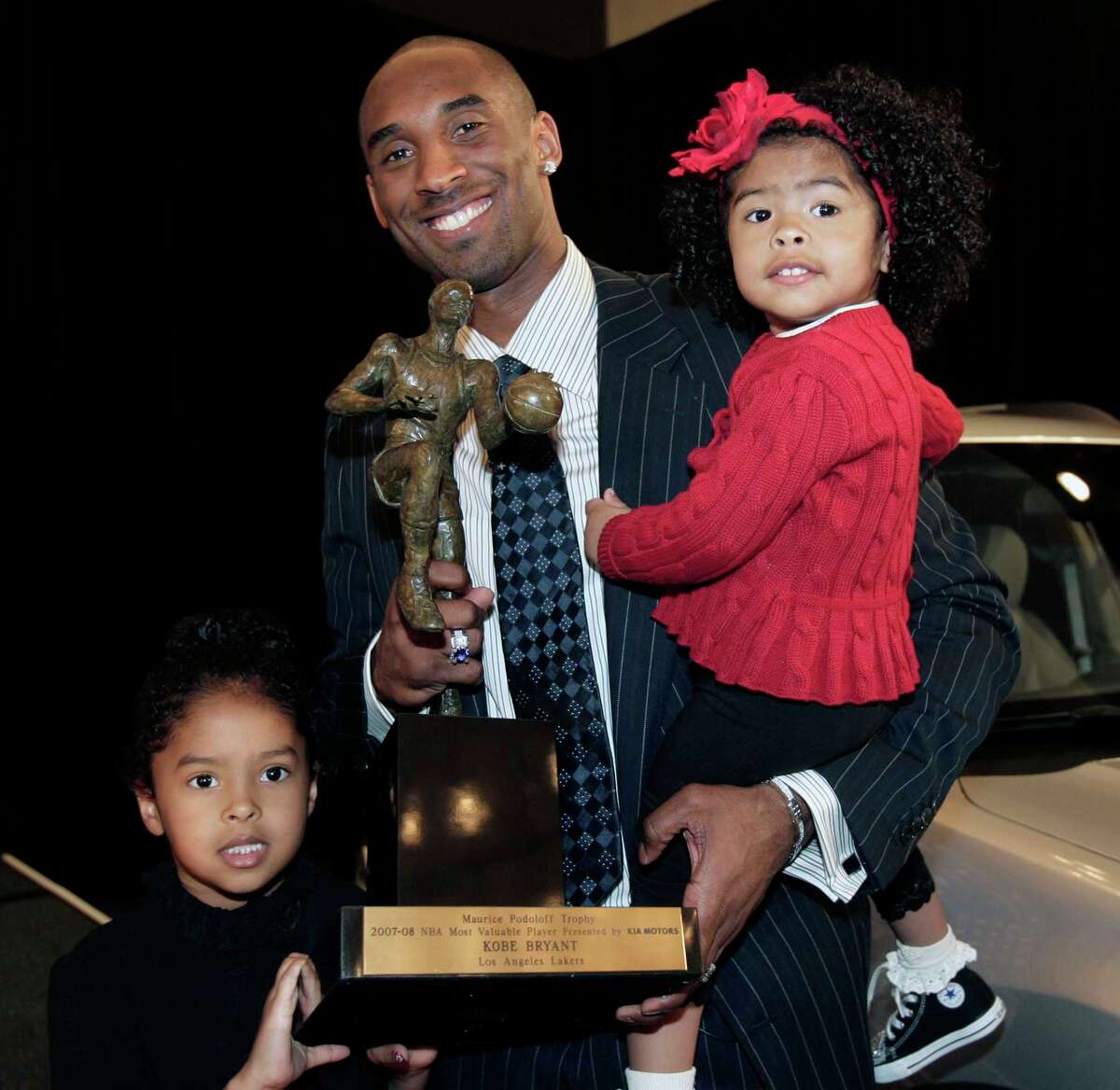 Los Angeles Lakers star Kobe Bryant holds the NBA's Most Valuable Player trophy with his daughters Gianna, right, and Natalia, left,Tuesday, May 6, 2008, in Los Angeles. Bryant received 82-first-place votes and 1,105 points in the media vote. (AP Photo/Ric Francis)