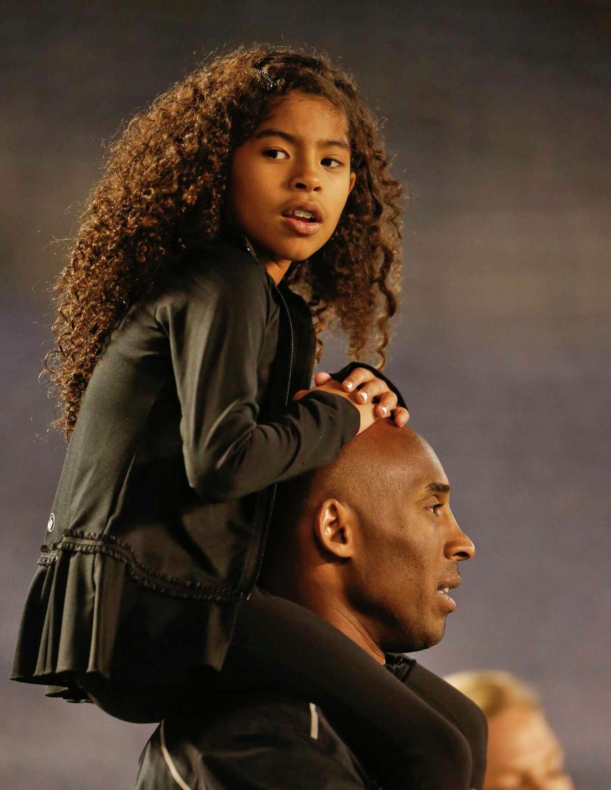 Gianna Bryant sits on the shoulders of her father, Kobe, as they attend a 2014 women's soccer match between the United States and China in San Diego.