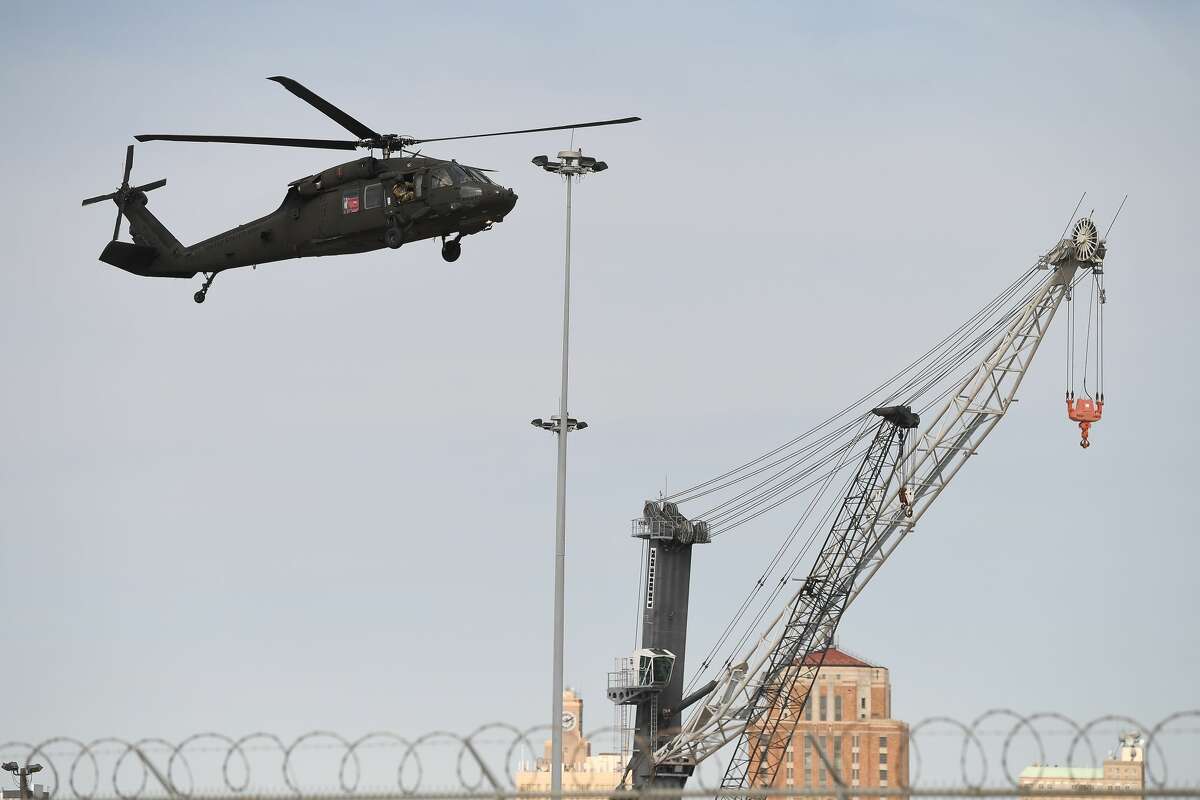 Military helicopters descend for a landing at the Port of Beaumont Wednesday morning. The aircraft are part 1,500 military cargo being staged at the port as part of the U.S. Army 842nd Transportation Battalion's operation to deploy the equipment to Europe for 1st Combat Aviation Brigade's training exercises with NATO allies. The U.S. Army's "Demon Brigade" will be loaded onto ships due to arrive at the port next week. Photo taken Wednesday, January 27, 2021 Kim Brent/The Enterprise