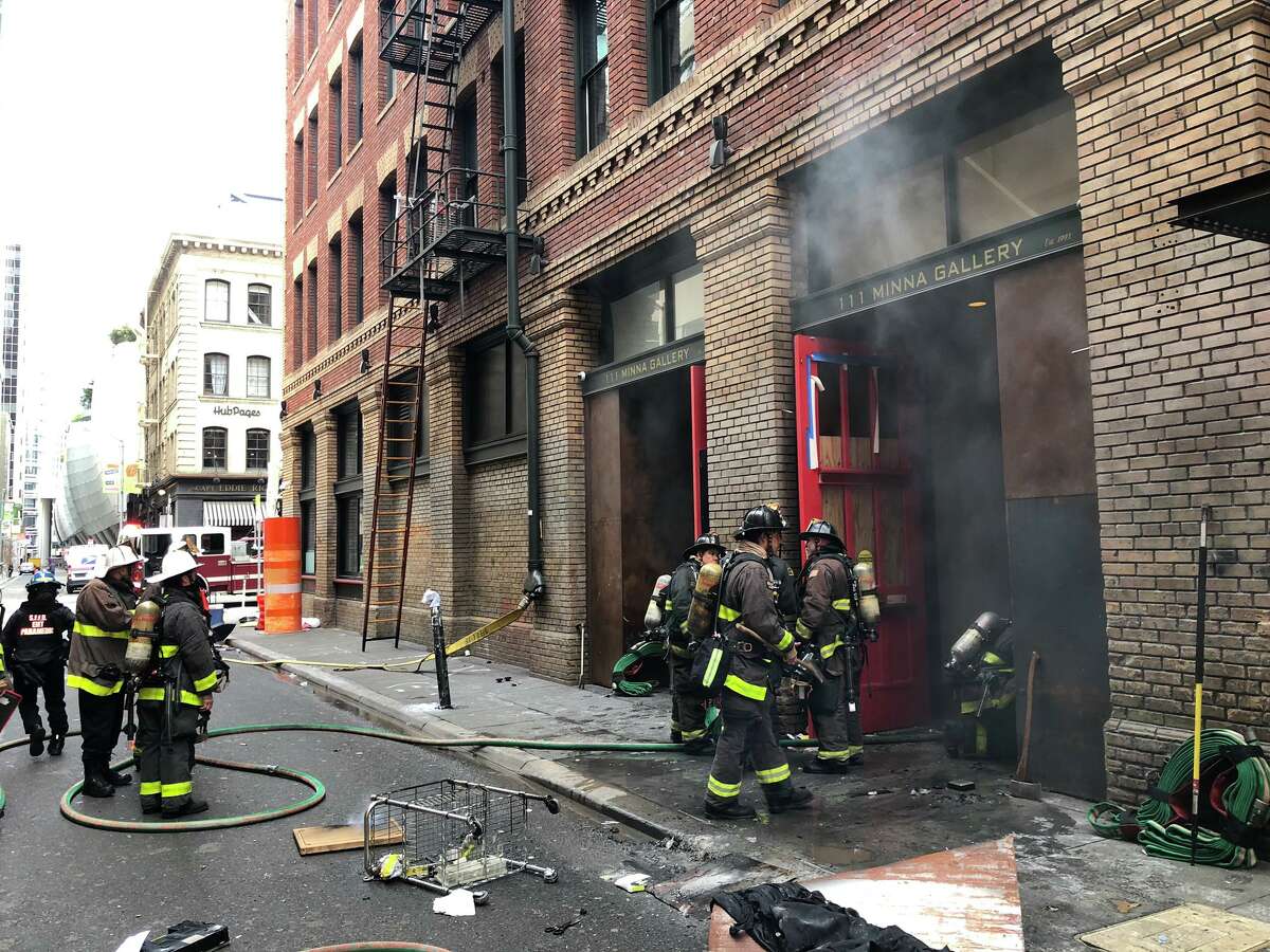 San Francisco firefighters control a fire that broke out at 111 Minna St. on Wednesday, Jan. 27, 2021.