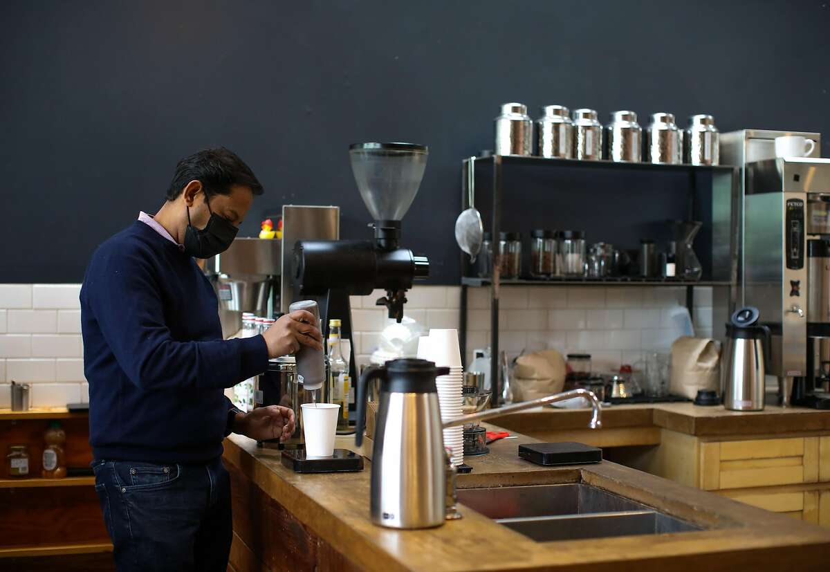 Kinani Ahmed makes a drink inside his coffee shop, Sextant Coffee, on Tuesday, January 26, 2021, in San Francisco, Calif. Sextant Coffee used to be bustling with tech workers in SOMA. Now it's nearly empty.