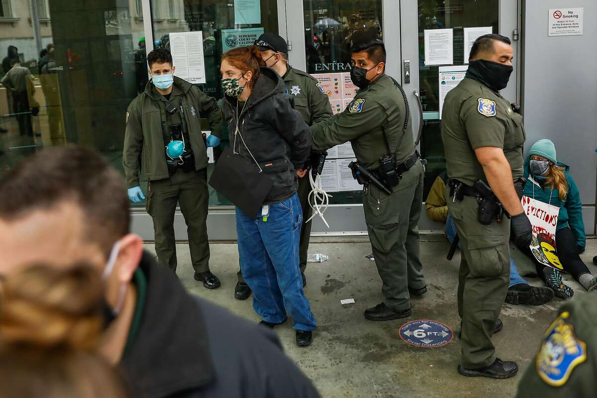 Sheriffs arrest a demonstrator who was blocking the door to the Santa Clara County Courthouse in San Jose in an attempt to halt eviction proceedings from taking place on Wednesday, Jan. 27, 2021 in San Jose, California.