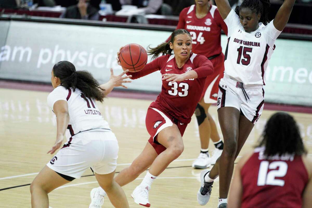 Arkansas’ Chelsea Dungee (33) drives to the basket against South Carolina’s Laeticia Amihere (15) earlier this month in Columbia, S.C.