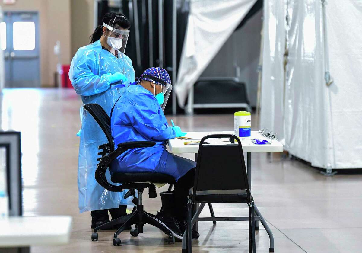 Medical personnel sort through information at the Freeman Coliseum complex on Friday, Jan. 15, 2021, where COVID-19 patients were being given infusions of antibodies.