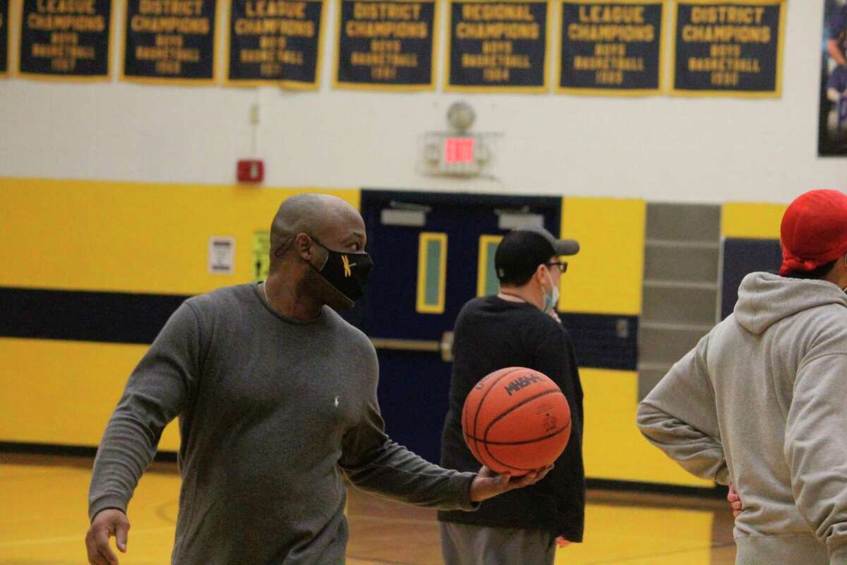 Baldwin assistant coach Shawn WIlliams (left) keeps an eye on the action during Tuesday's basketball practice. (Star photo/John Raffel)