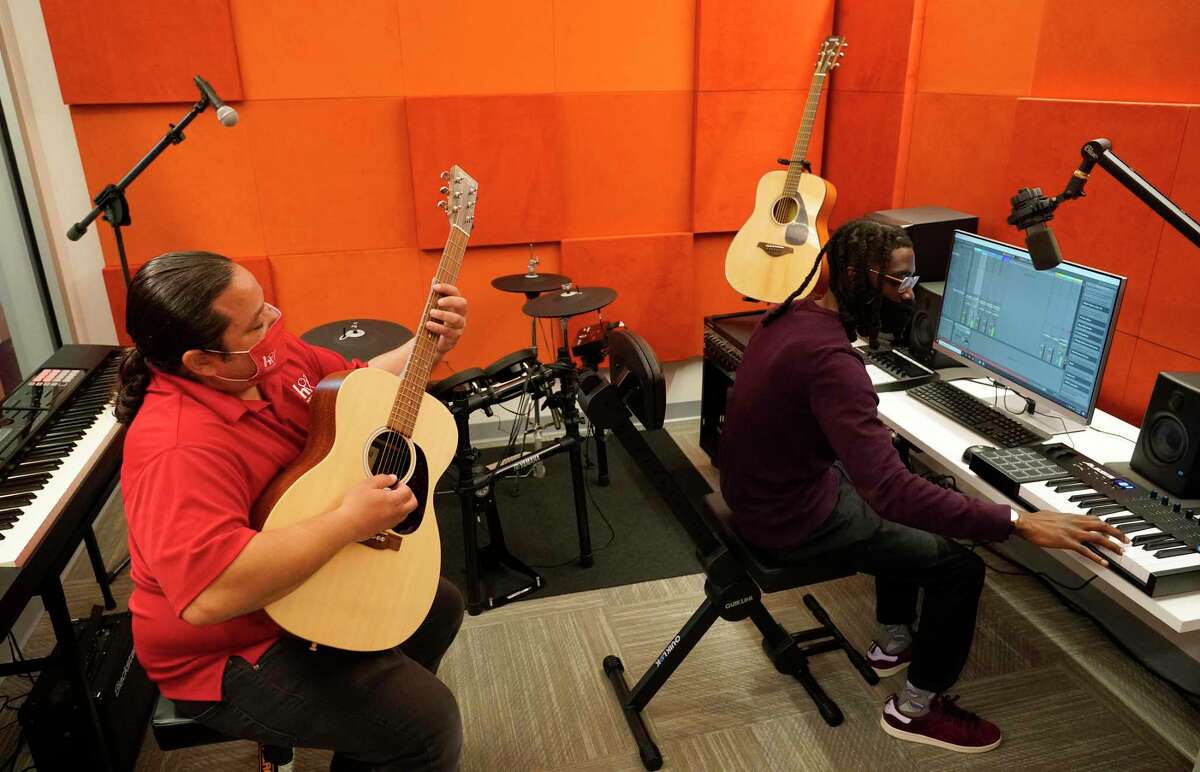 John Plail, a library services specialist, left, and Kenneth Thomas a senior customer clerk, right, demonstrate the music studio at the Dixon TECHLink Library Powered by Aramco, 8002 Hirsch Road, Wednesday, Jan. 27, 2021 in Houston. The new library was rebuilt in the same location as the Amanda Dixon Neighborhood Library which was damaged beyond repair after Hurricane Harvey. It bridges the technology divide with the latest interactive technology to enhance learning with free access to computers and state-of-the-art technologies.