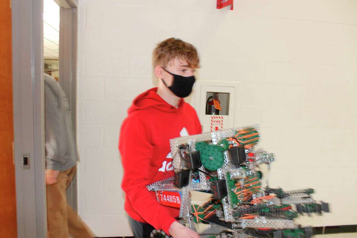 VEX teams bring in their robots when called to participate in the semi finals. (Colin Merry/Record Patriot)