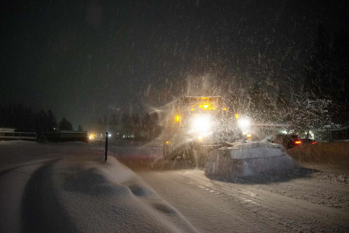 A snow plow clears freshly fallen snow off the street in South Lake Tahoe, Calif. on Jan. 28, 2021. Residents of South Lake Tahoe brace for and begin to dig out of massive snowfall.
