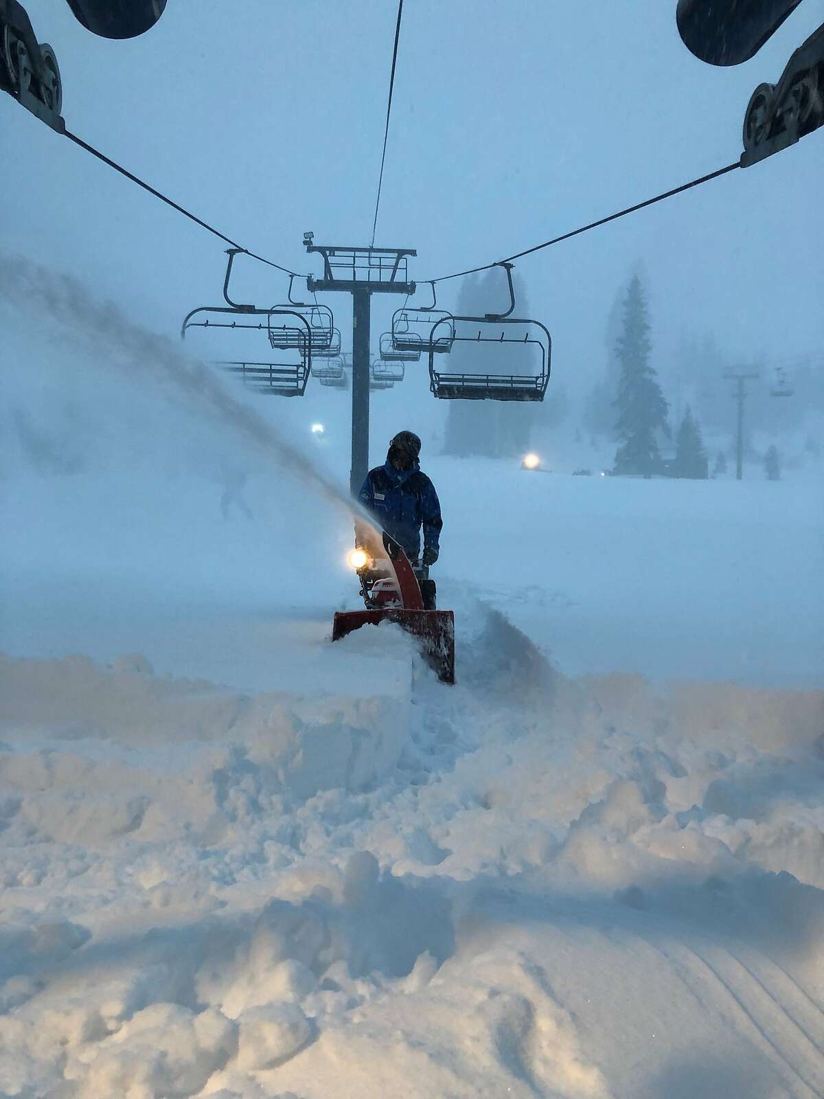 A staffer at Sugar Bowl clears a path through the snow on Wednesday morning.