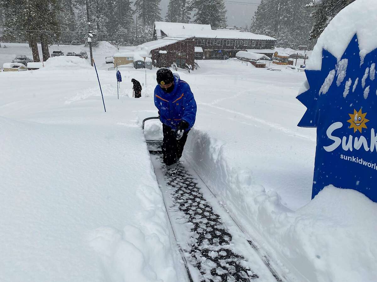 A staffer clears a path through the snow at Homewood Ski Resort on Thursday, Jan. 28.