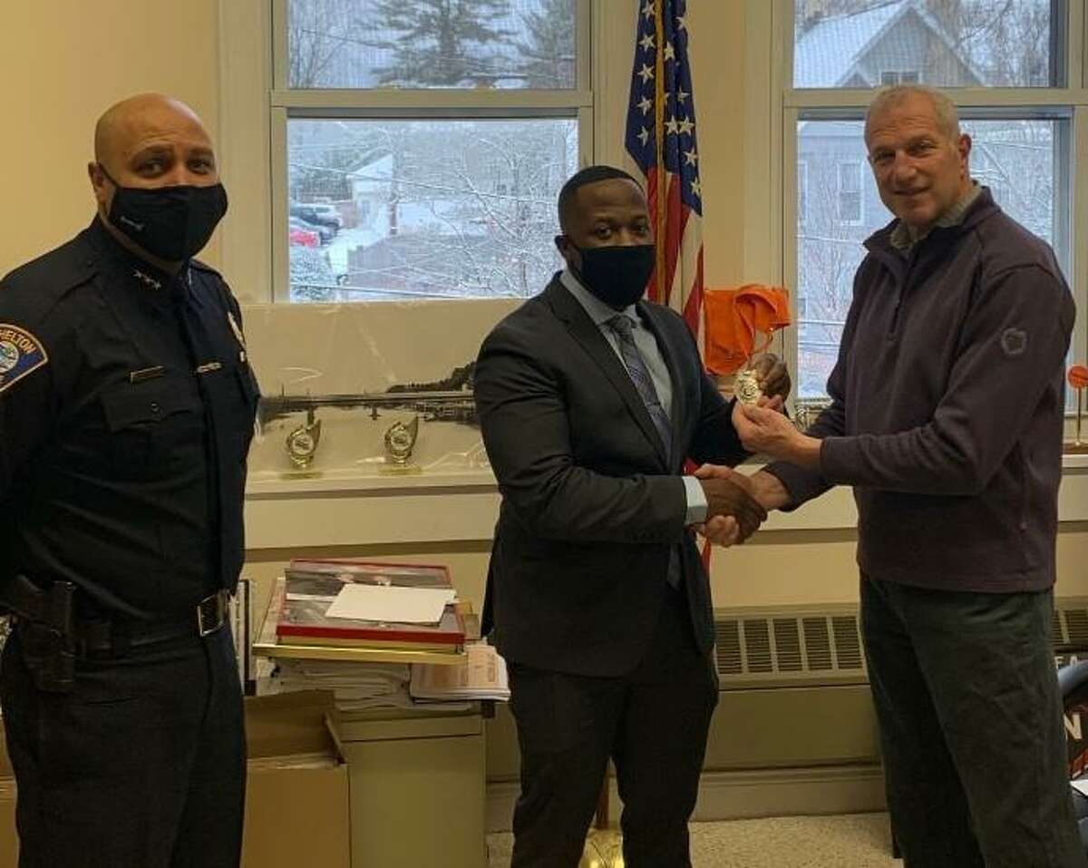 Mayor Mark Lauretti, right, swore in new police officer Jerel Nembhard, center, as police Chief Shawn Sequeira looks on on Wednesday, Jan. 27, at City Hall. also a Shelton resident.