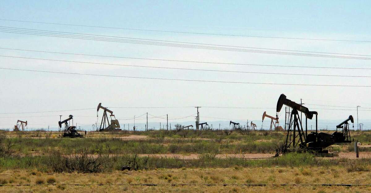 Oil rigs stand in the Loco Hills field on U.S. Highway 82 in Eddy County near Artesia, N.M., one of the most active regions of the Permian Basin. The world’s biggest oil companies are poised for a sharp V-shaped recovery from the worst oil bust in decades caused by the global pandemic, according to a new report.
