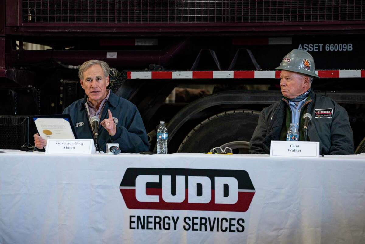 Texas Governor Greg Abbott prepares to sign an executive order during a round table discussion at Cudd Energy Services, Thursday, Jan. 28, 2021, in Odessa, Texas. Governor Abbott took part in a round table with oil and gas workers, energy leaders and other industry advocates to discuss how Texas can continue to support the oil and gas industry nearly a year after the outbreak of COVID-19. (Eli Hartman/Odessa American via AP)