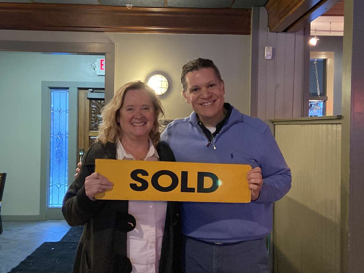 Century 21 Boardwalk Realtor Gini Pelton and restaurant owner Ted Fricano celebrate the sale of 440 River St.