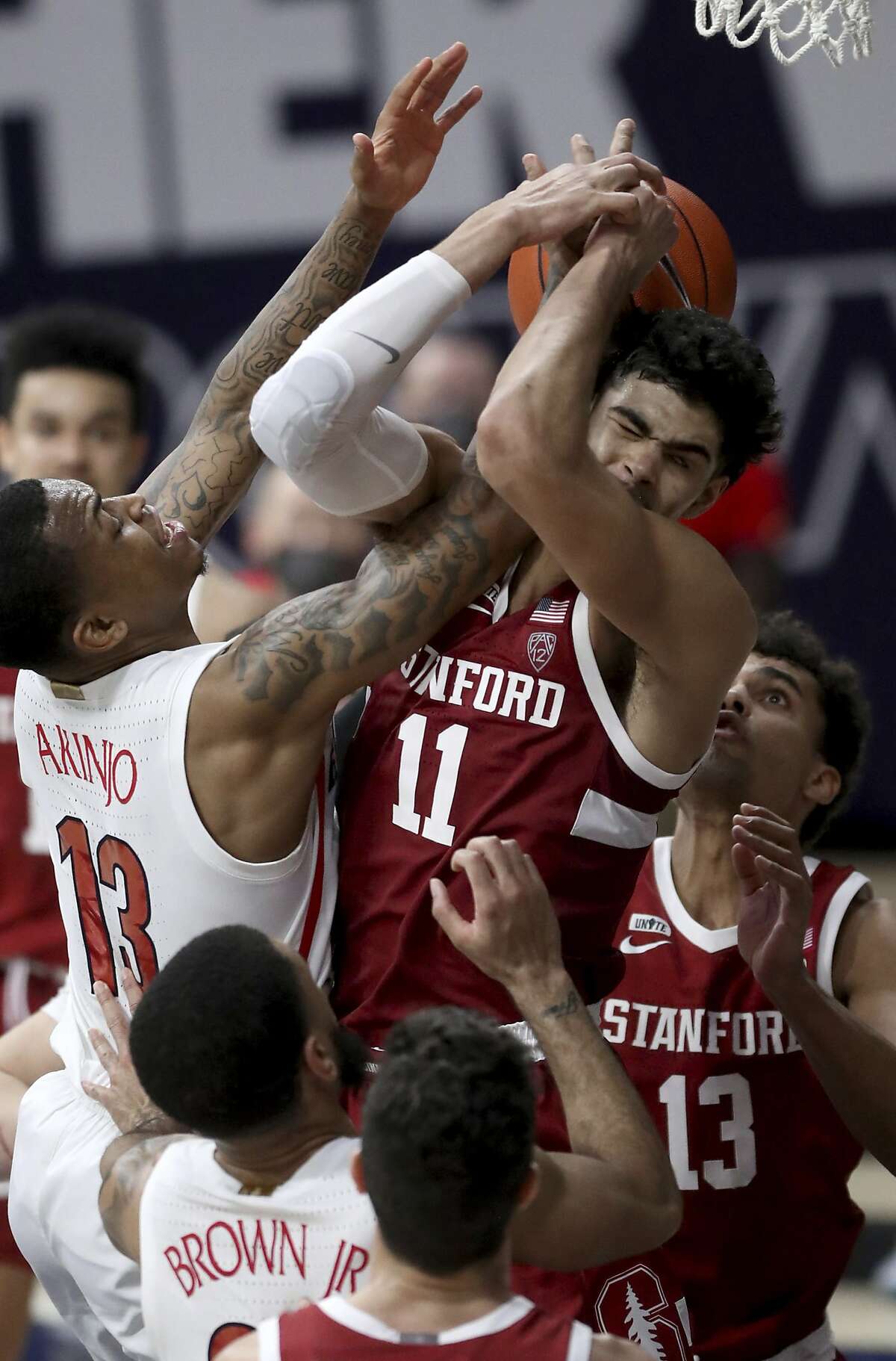 Stanford forward Jaiden Delaire finds Arizona guard James Akinjo to be a real handful Thursday.