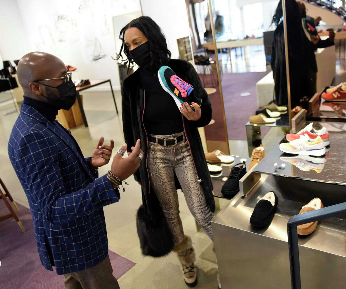 Style adviser Withley Verdiner assists Greenwich's Jillian Aufderheide at the new Barneys at Saks located at 200 Greenwich Ave., in downtown Greenwich, Conn., on Monday, Jan. 25, 2021. The store features men’s shoes and accessories on the first floor and women’s contemporary fashion on the second floor, marking the first time Saks has offered men's merchandise in Greenwich