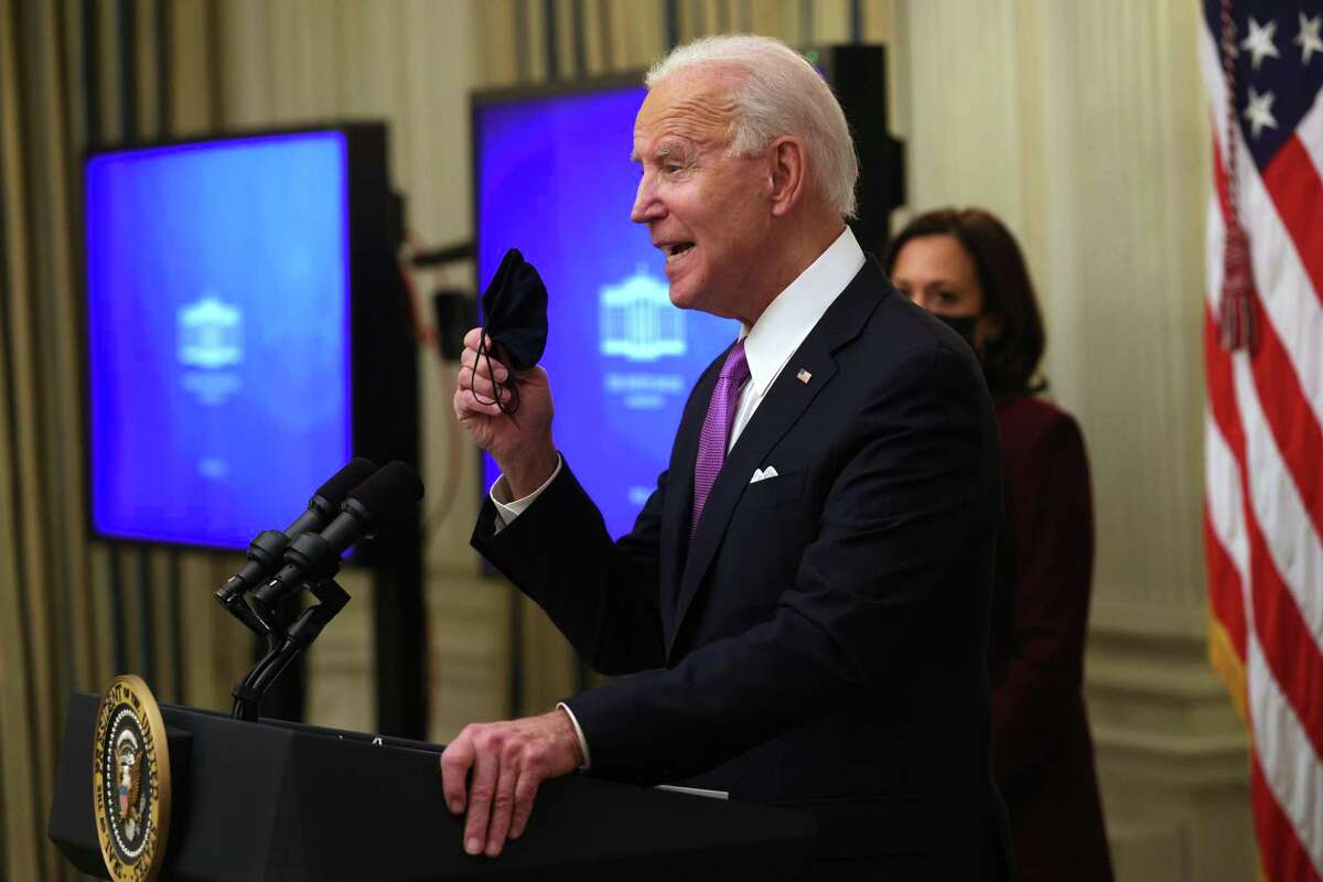 President Joe Biden holds up a mask earlier this month. With new COVID variants emerging, better masking will be needed.