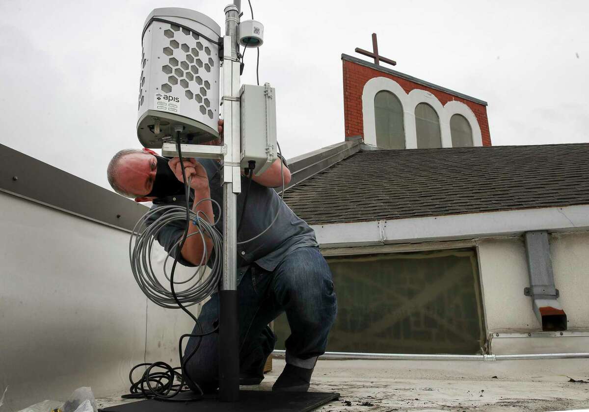 Corey Williams, research and policy director for Air Alliance Houston, installs an air monitor Monday, Jan. 25, 2021, at San Pedro Episcopal Church in Pasadena. WIlliams said that TCEQ's air monitoring network isn't necessarily designed with local public health in mind, which is why they sought to install the monitor near two schools.