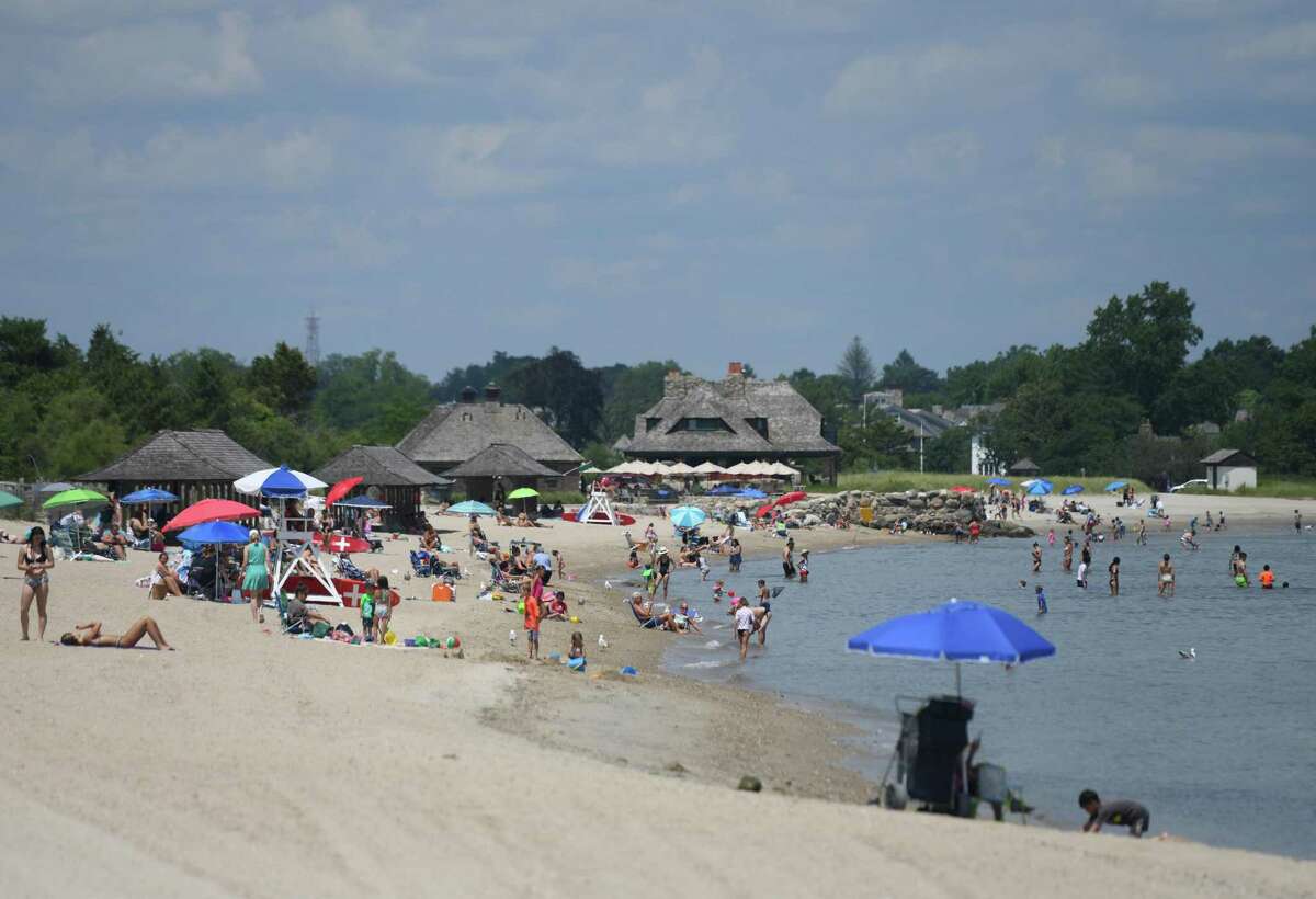 Beachgoers soak up the sun on the beach at Greenwich Point last July. Residents will be facing higher fees for the beach and golf courses this summer unless they act soon in getting their yearly passes.