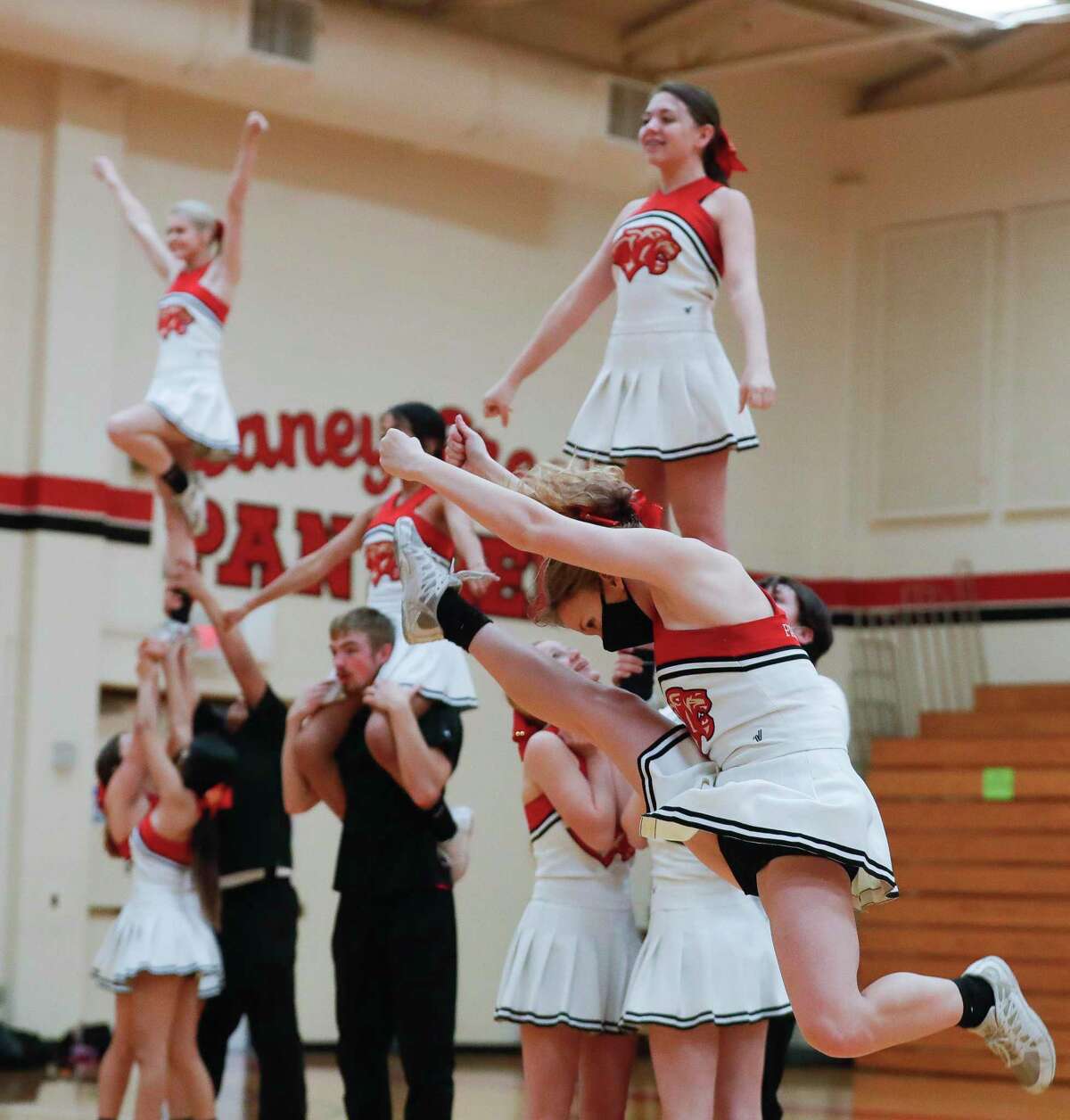 Caney Creek High School cheerleader Bailey LaCaze a performs a front hurdler as she takes part in a contest routine with teammates, Thursday, Jan. 28, 2021, in Grangerland. The team finished fourth in the Coed division of the UIL State Spirit Championships on Jan. 13 in Fort Worth.