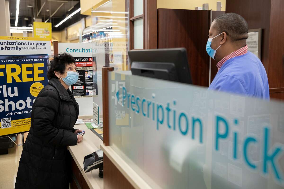 Ramona Cohen, 75, speaks to an employee at a Safeway grocery store pharmacy in Washington D.C. on Jan. 15, 2021. MUST CREDIT: photo for The Washington Post by Amanda Andrade-Rhoades.