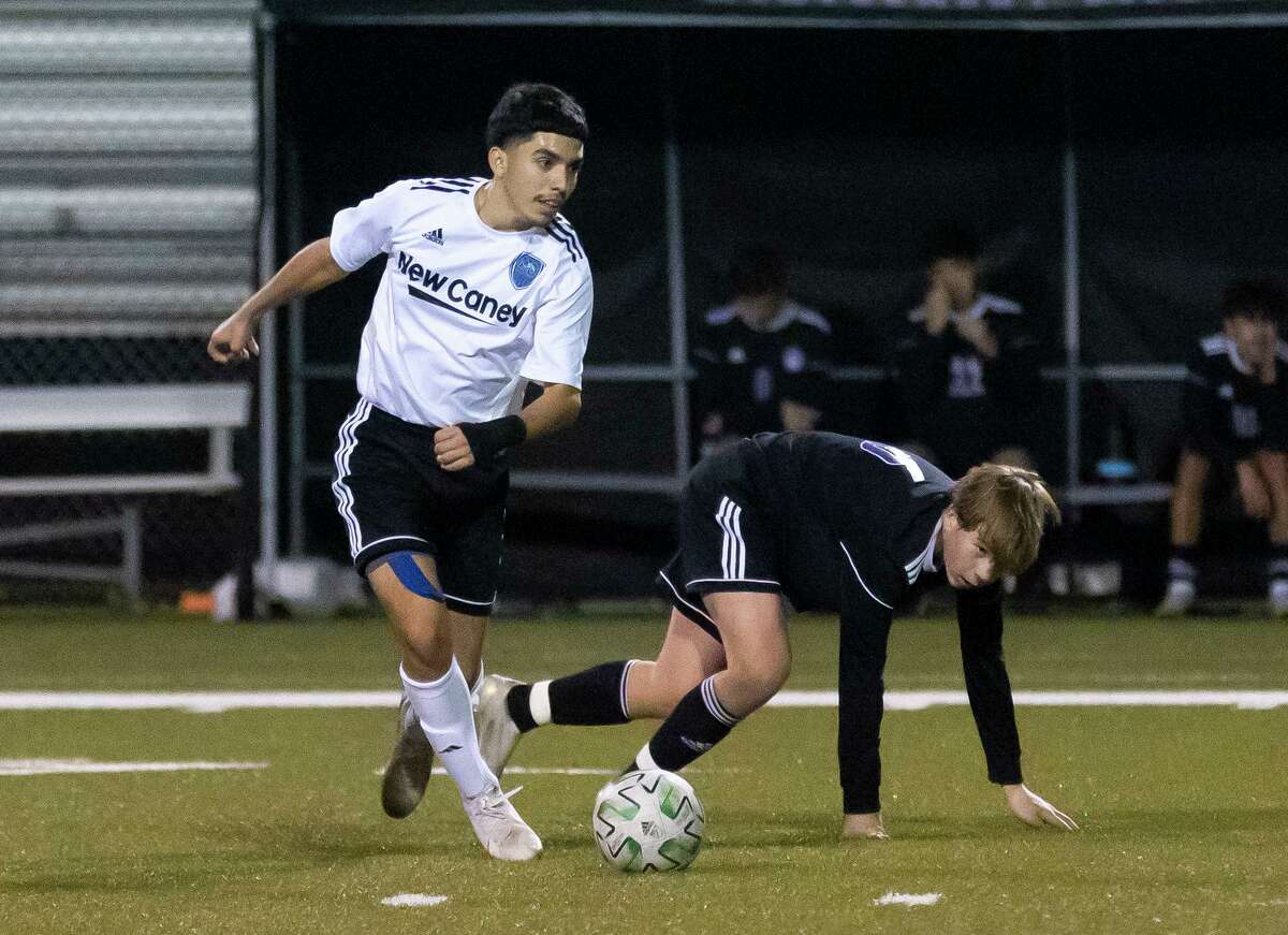 New Caney Steven Aureoles (5) steals control of the ball from Montgomery Chandler Sutherland (6) during the first period of a District 20-5A high school soccer match at Montgomery High School, Friday, Jan. 29, 2021, in Montgomery.