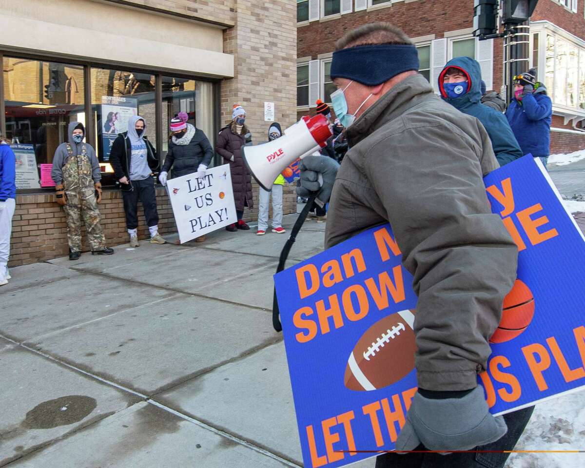 Paul Schafer, of Latham, and parent of Shaker High students uses a bullhorn to talk to athletes, parents and coaches who gathered outside the Albany County office building on State Street on Saturday, Jan.29, 2021, calling on County Executive Dan McCoy to allow so-called high risk sports to begin on Feb. 1 (Jim Franco/special to the Times Union.)