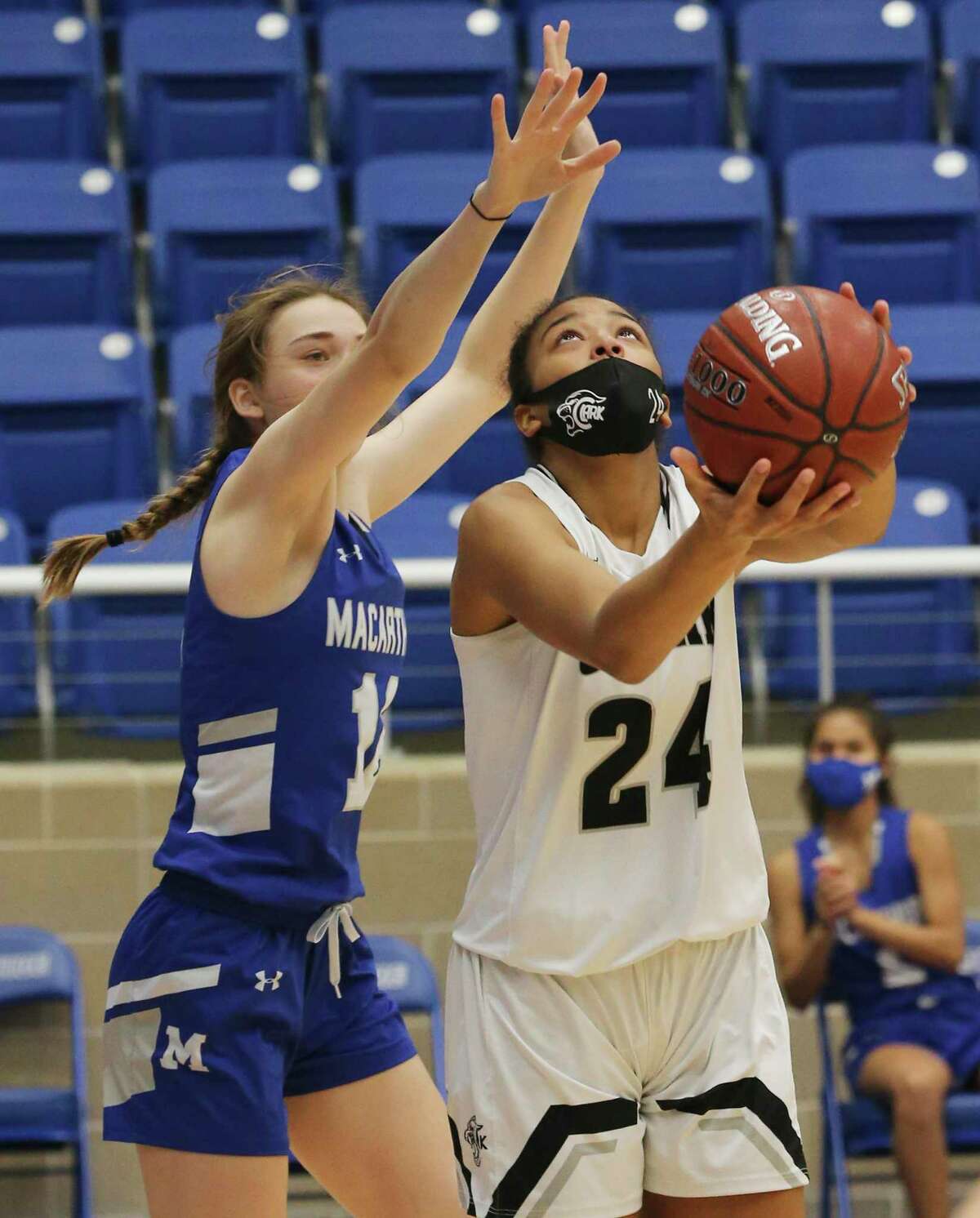 Clark's Aaliyah Roberson (24) looks to score against MacArthur's Nicole Wallace (12) in girls basketball at Northside Sports Gym on Friday, Jan. 29, 2021. The Cougars defeated the Brahmas, 58-34, to advance to the next round.