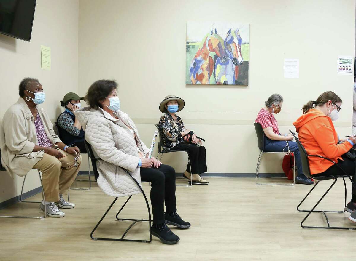 Recently vaccinated people wait for 15 minutes after getting the Moderna COVID-19 vaccine at HOPE Clinic in Houston on Saturday, Jan. 30, 2021.