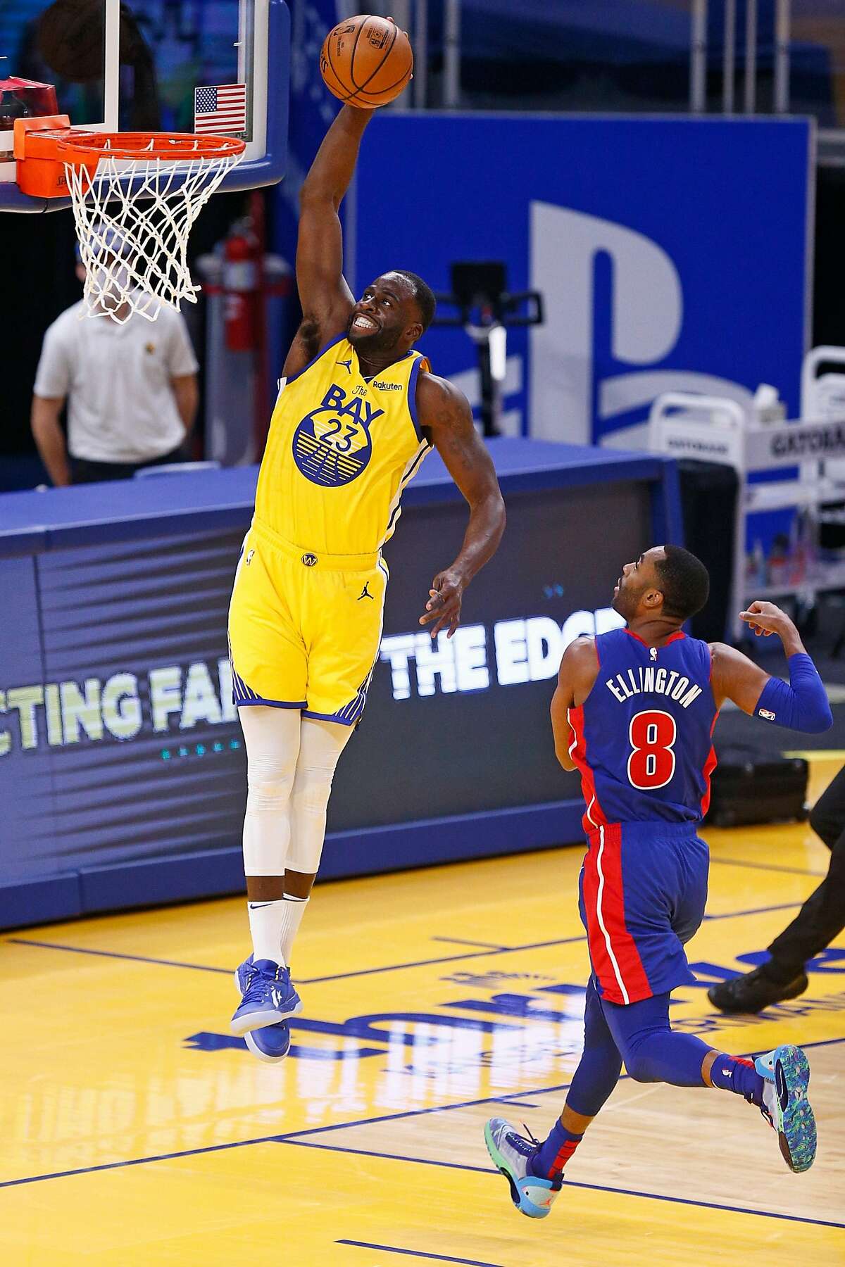 Golden State Warriors forward Draymond Green (23) dunks against Detroit Pistons guard Wayne Ellington (8) in the first period of an NBA game at Chase Center on Saturday, Jan. 30, 2021, in San Francisco, Calif.
