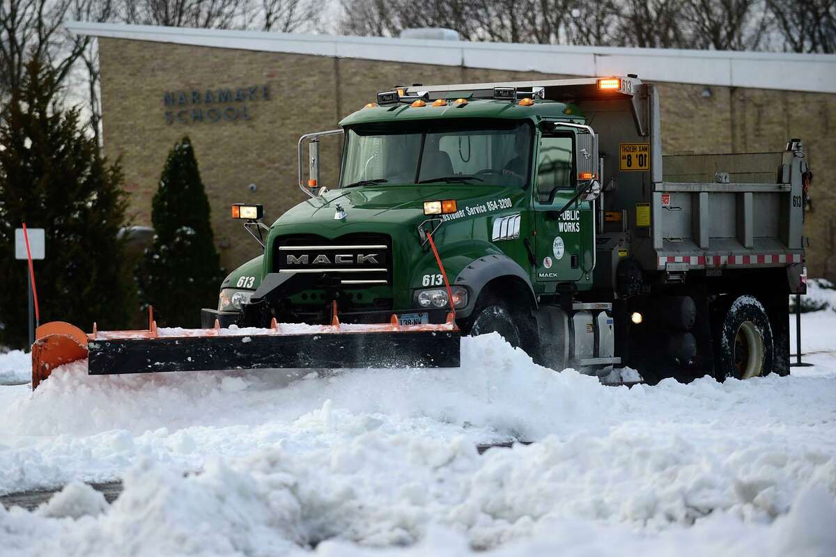 Norwalk DPW crews remove snow from parking lot at Naramake Elementary School Friday, December 18, 2020, in Norwalk, Conn.