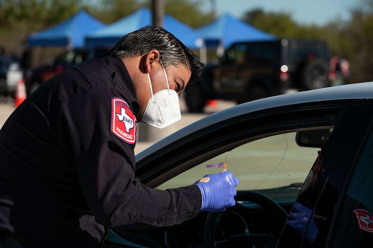 Paramedic David Esparza helps administer the Moderna Covid-19 Vaccine, Saturday, Jan. 2, 2021, during the COVID-19 Vaccine Drive Thru for Healthcare Workers at TAMIU.