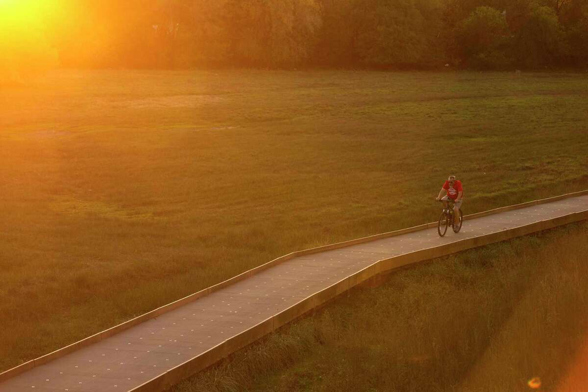 A bicyclist makes his way close to sunset one evening in 2019 along the Salado Creek section of the Howard W. Peak Greenway Trail System.