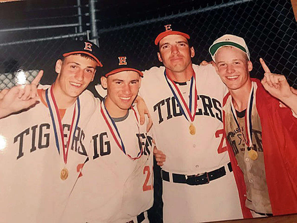 Left to right, Joe Blasingim, Tom Price, pitching coach Mike Waldo and Mark Little celebrate after Edwardsville won the Class AA state championship in 1990.