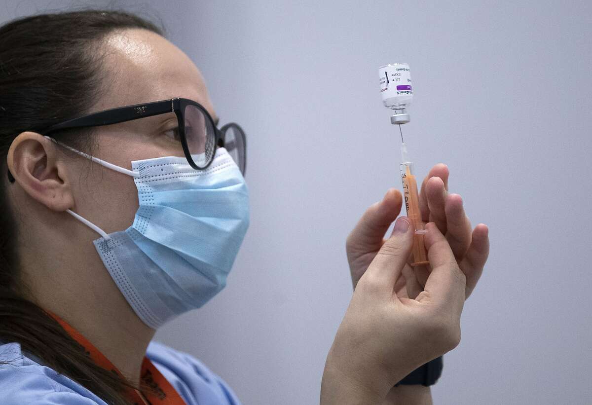 A member of the vaccination team prepares a syringe with a dose of the AstraZeneca / Oxford Covid-19 vaccine in Edinburgh, Scotland on February 1, 2021.