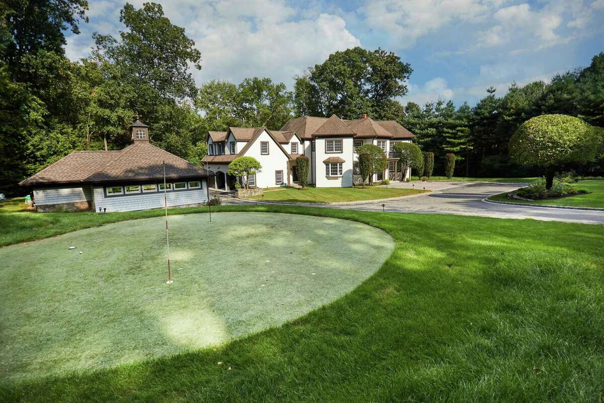 Par 3 golf green at 17 Woodway Lane, Westport. Before reaching the 8,059-square-foot, 15-room stucco colonial house, visitors to this 2.65-acre level property will notice the Par 3 golf green. At the opposite end of the manicured front lawn there is a 54-yard golf tee box. And for occasions like this week, when Mother Nature dumped about a foot of snow on the tee and green, there is a sizable space in the basement that can be used as an indoor golf practice room with plenty of room for a simulator.