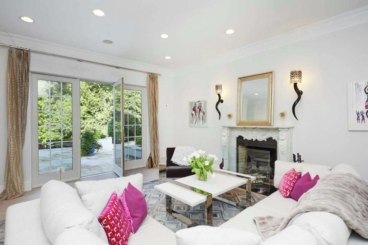 Formal living room with French doors to the patio at 17 Woodway Lane, Westport. On the second floor there are four en suite bedrooms including the luxurious master suite. It features two walk-in closets, a private bath with radiant heated flooring and a private balcony. In a private second floor wing there is a large bonus space with a full bath that is currently used as a game room, but could be converted into a guest bedroom. This house, which was built in 2002 in the Coleytown neighborhood, seems quite remote, and there is the mistaken impression that it is far from town because GPS indicates travelers must pass through the town of Wilton to reach it. In truth, this property is only about seven minutes from the Merritt Parkway at Exit 41, the Country Store & Delicatessen, the Westport-Weston Family YMCA, and the Museum of Contemporary Art, or MoCA (formerly the Westport Arts Center). The shops and restaurants in the centers of Westport and Weston are not far, nor is the Saugatuck train station.