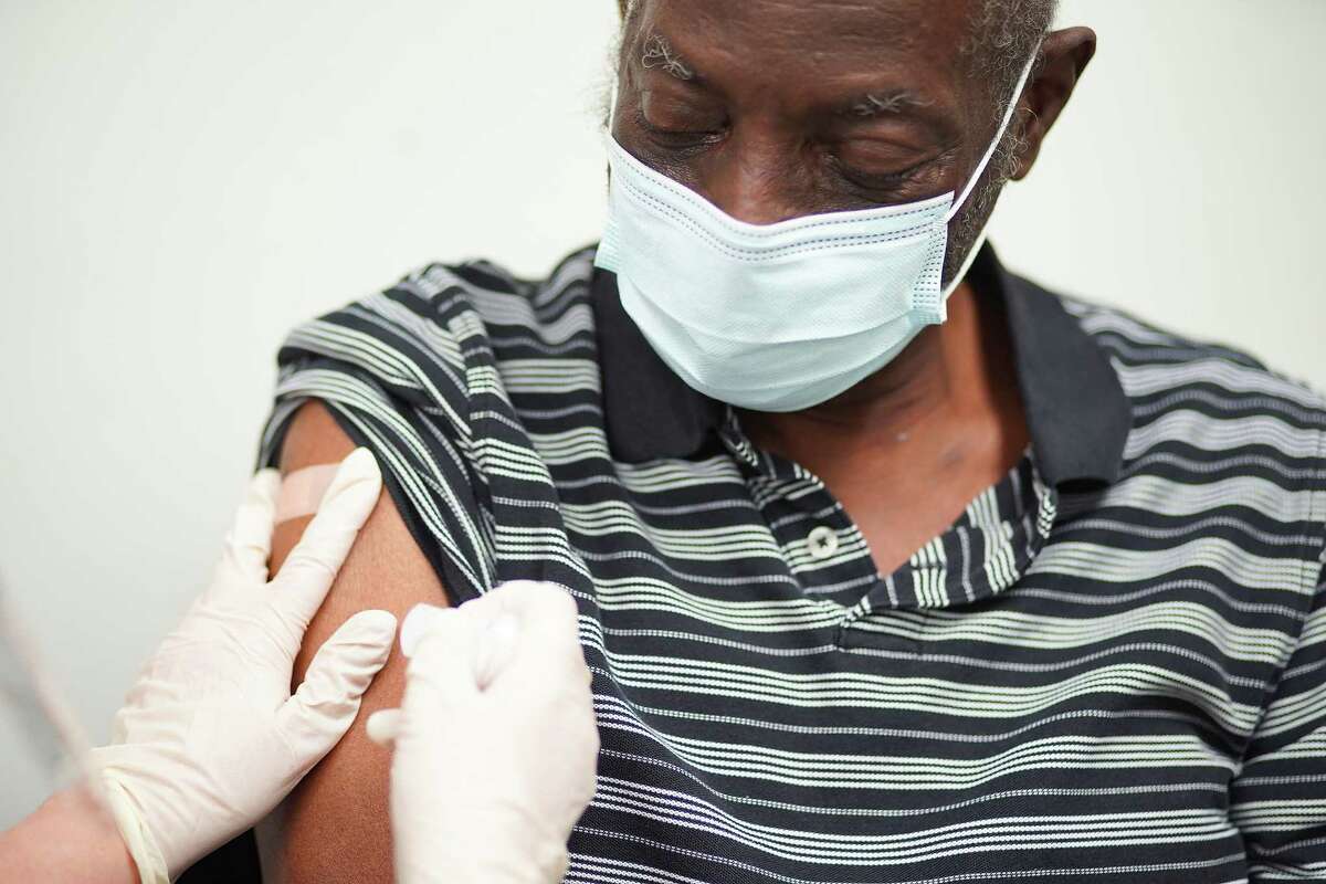 Donald Henderson gets his first dose of the COVID-19 vaccine at HOPE Clinic in Houston on Saturday, Jan. 30, 2021.