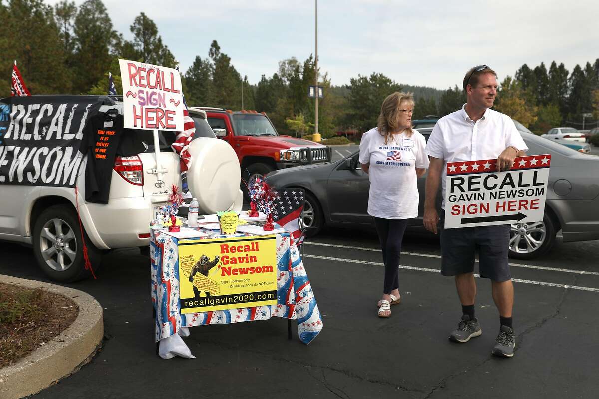 Donna Jones (middle right) has signs around her desk and car in the parking lot of K-mart to collect signatures recalling governor Gavin Newsom on Sept. 26, 2020, in Grass Valley (Nevada County).