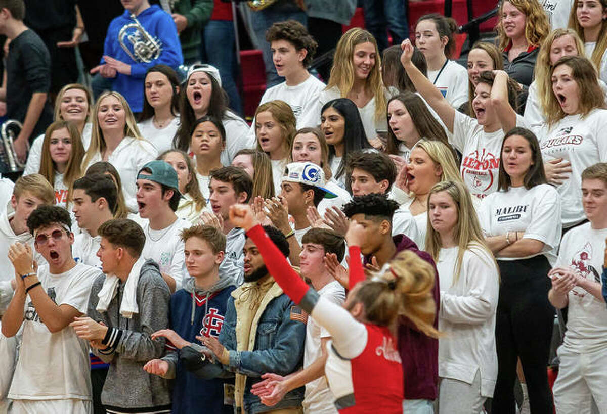 Alton students fill the Redbird Nest section of bleachers at a AHS boys basketball game last year at Alton High in Godfrey. If Region 4 moves to Phase 4 mitigation by the weekend, Alton will host Collinsville in three games Saturday, but with only 50 people spectators in the gym. Currently, the region is in Tier 2.