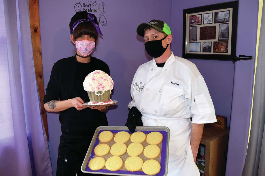 Anastasia (left) and Karen Bergner-McNeece hold some their baked treats — freshly made sugar cookies and a giant cupcake. Photo: Rochelle Eiselt | Journal-Courier