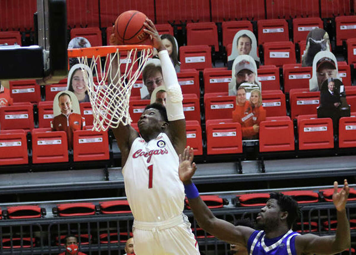 SIUE’s Mike Adewunmi (1) dunks off a lob pass in the second half against Eastern Illinois on Tuesday at First Community Arena in Edwardsville.