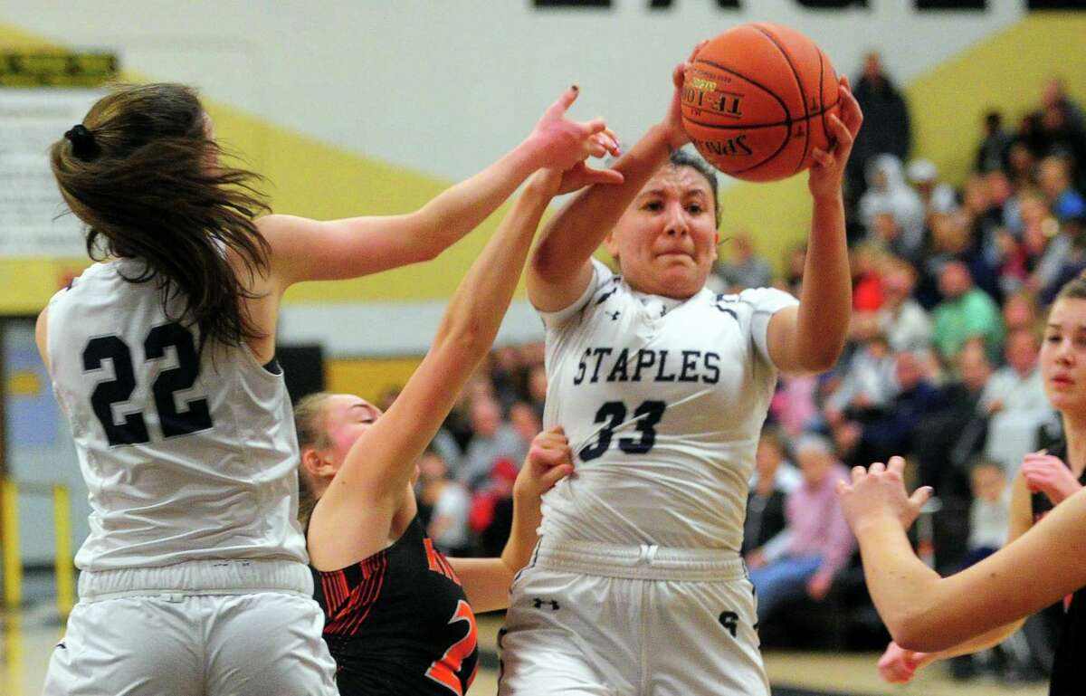 Staples' Marley Lopez-Paul (33) recovers a rebound during FCIAC Girls' Basketball Championship action against Ridgefield in Trumbull, Conn., on Thursday Feb. 27, 2020.