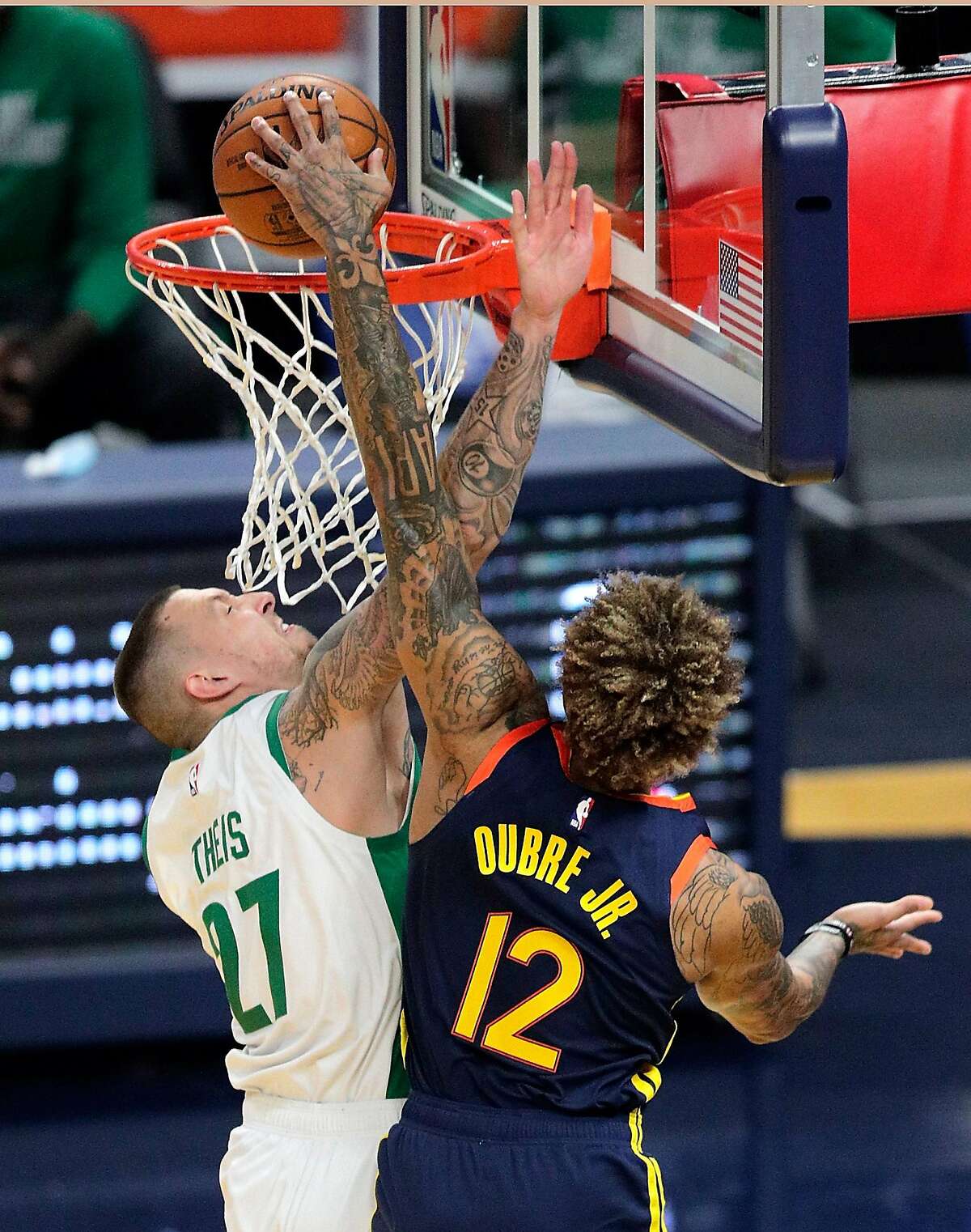 Kelly Oubre Jr., (12) dunks while defended by Daniel Theis (27) in the first half as the Golden State Warriors played the Boston Celtics at Chase Center in San Francisco, Calif., on Tuesday, February 2, 2021.