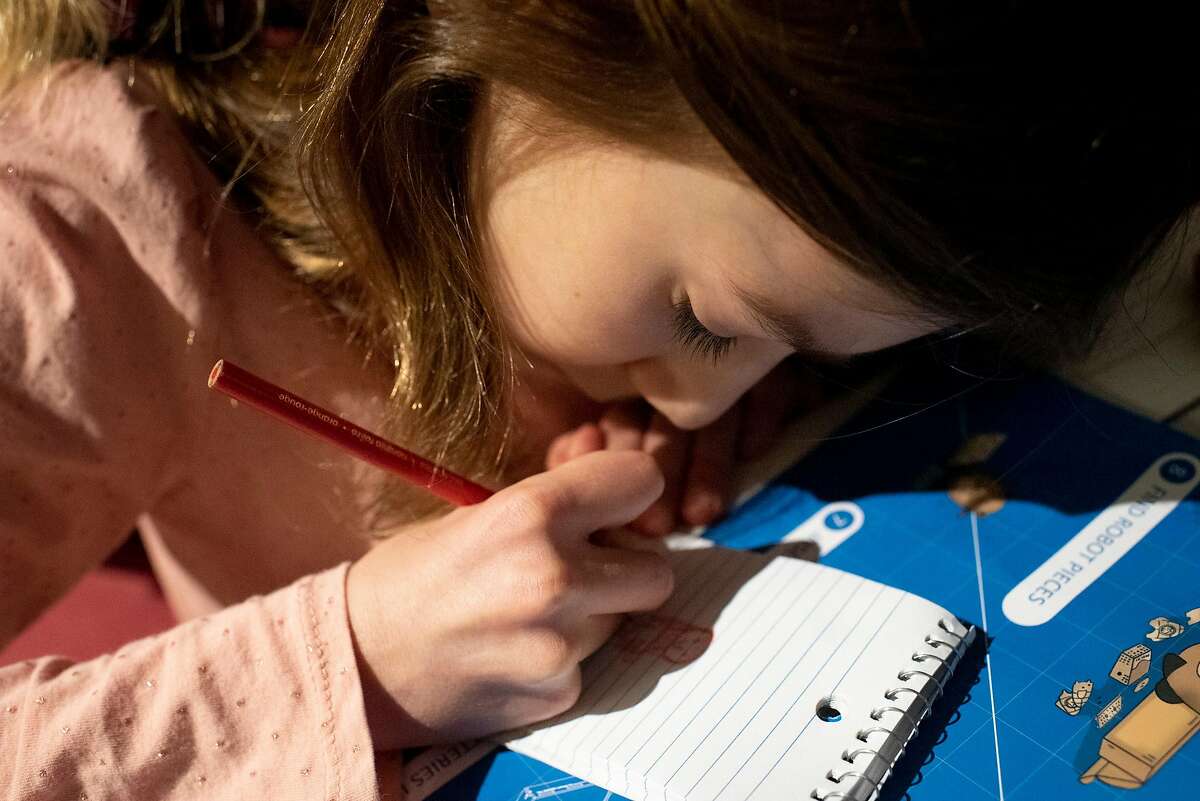 Vardeni Vardanyan, 8, a second-grader at Marshall Elementary School, draws in the evening at her Mission Bay apartment in San Francisco, Feb 2, 2021.