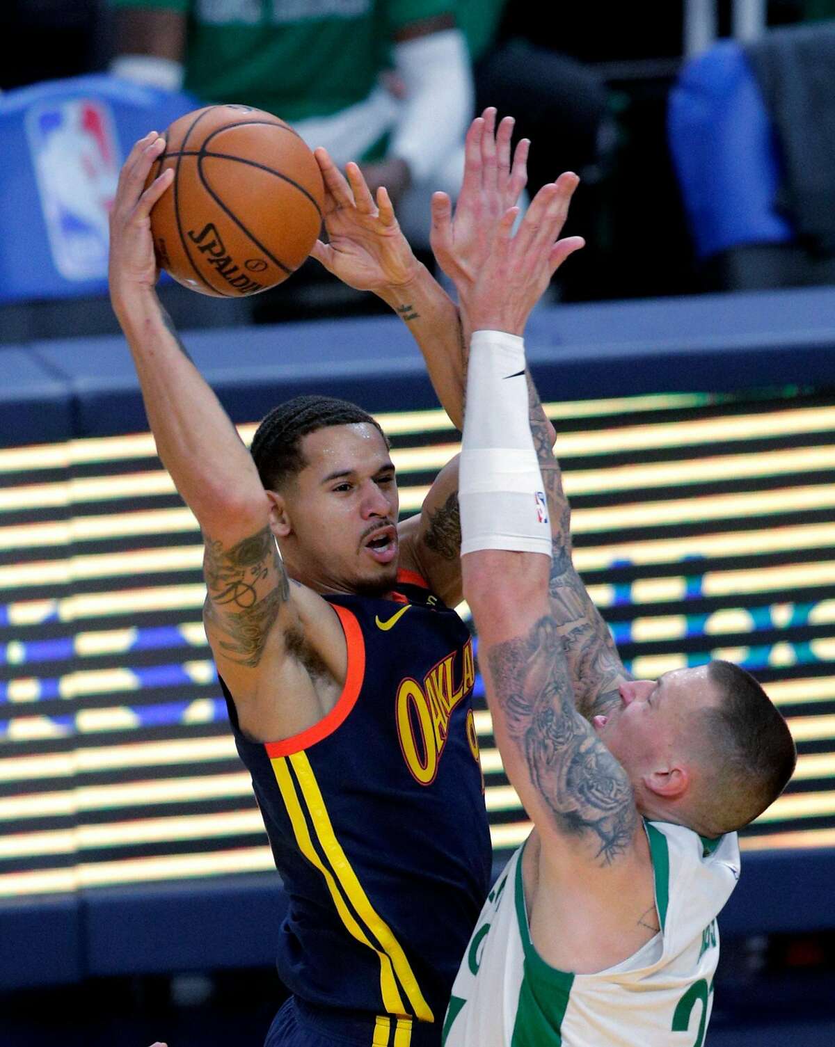 Juan Toscano Anderson (95) passes over Daniel Theil (27) in the first half as the Golden State Warriors played the Boston Celtics at Chase Center in San Francisco, Calif., on Tuesday, February 2, 2021.
