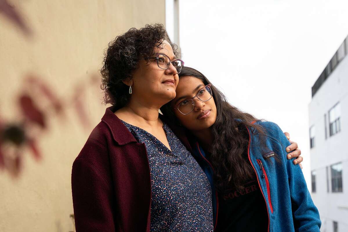 Joya Pramanik, 53, left, stands for a photo with her daughter, Opshory Choudhury, 15, a sophomore at Lowell High School, who is taking virtual classes from her home in San Francisco.
