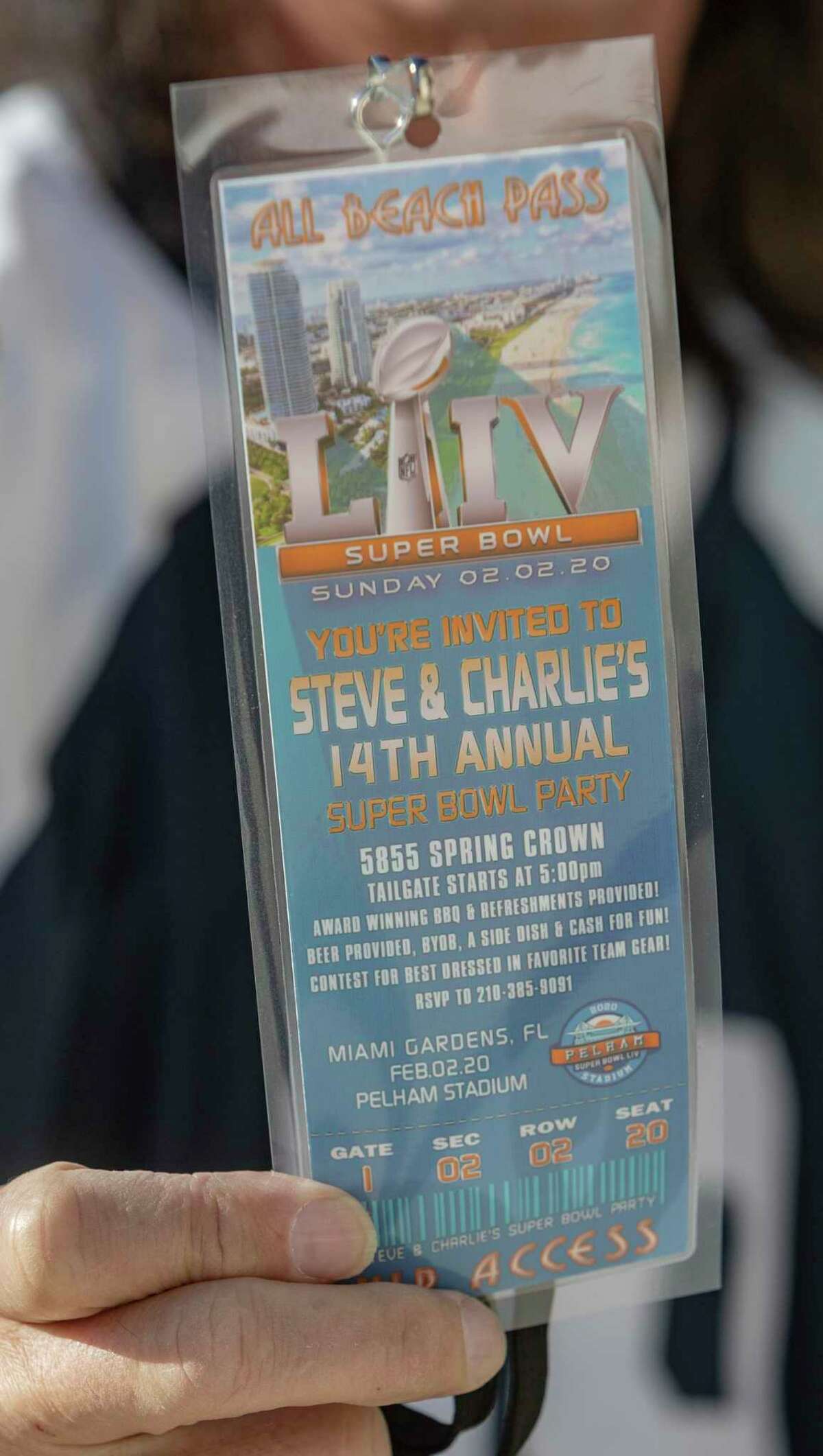 Steve Pelham displays one of the "tickets" a graphic designer friend made as an invitation to the 2020 neighborhood Super Bowl party he and his wife, Charlie, have hosted annually for 14 years. The Pelhams canceled it this year due to the coronavirus pandemic.